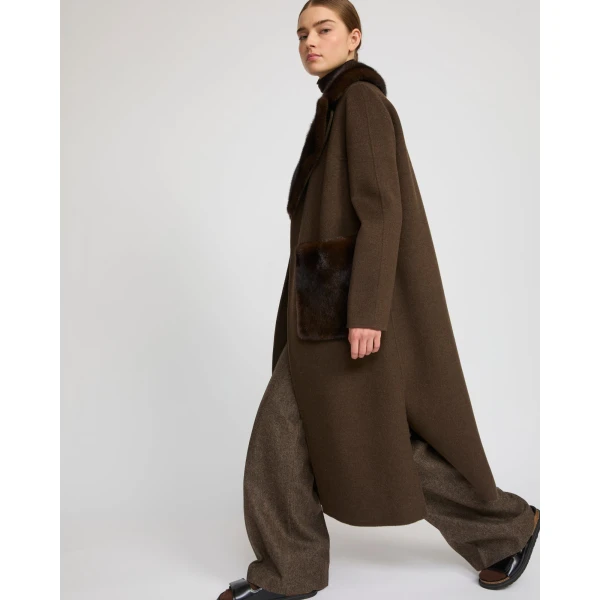 Woman wearing Yves Salomon shearling fur coat – luxury outerwear at Coveti