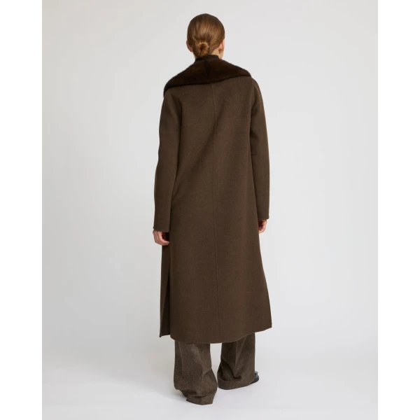Woman wearing Yves Salomon shearling fur coat – luxury outerwear at Coveti