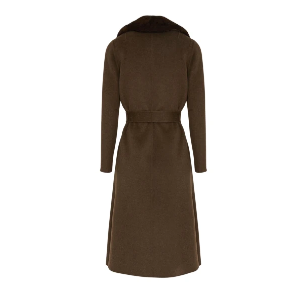 Woman wearing Yves Salomon shearling fur coat – luxury outerwear at Coveti