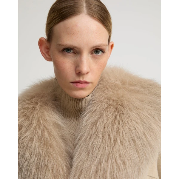 Woman wearing Yves Salomon shearling fur coat – luxury outerwear at Coveti