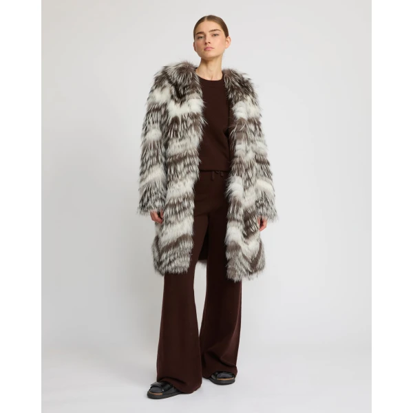 Woman wearing Yves Salomon shearling fur coat – luxury outerwear at Coveti