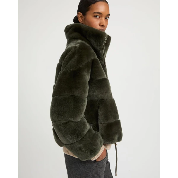 Woman wearing Yves Salomon shearling fur coat – luxury outerwear at Coveti