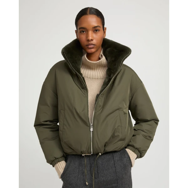 Woman wearing Yves Salomon shearling fur coat – luxury outerwear at Coveti