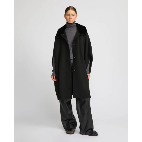 Woman wearing Yves Salomon shearling fur coat – luxury outerwear at Coveti