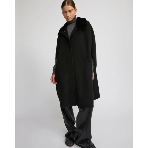 Woman wearing Yves Salomon shearling fur coat – luxury outerwear at Coveti