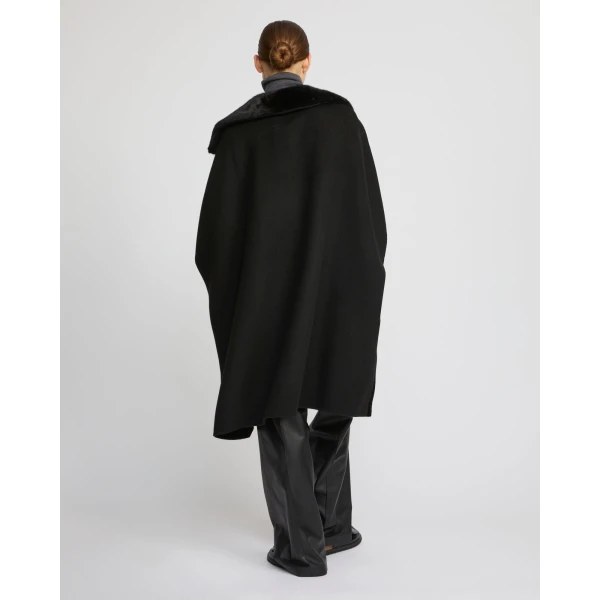 Woman wearing Yves Salomon shearling fur coat – luxury outerwear at Coveti