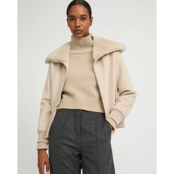 Woman wearing Yves Salomon shearling fur coat – luxury outerwear at Coveti