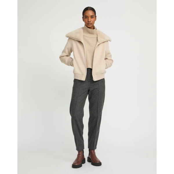 Woman wearing Yves Salomon shearling fur coat – luxury outerwear at Coveti