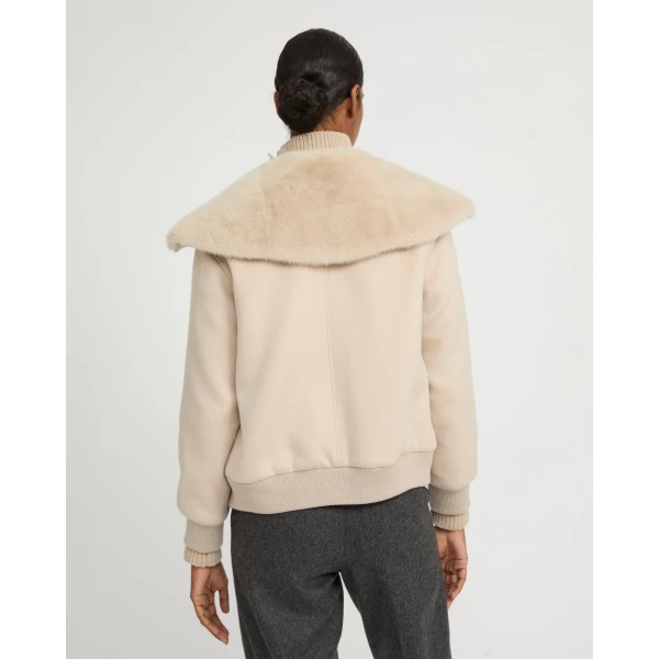 Woman wearing Yves Salomon shearling fur coat – luxury outerwear at Coveti