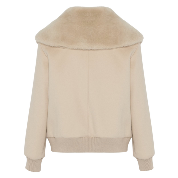 Woman wearing Yves Salomon shearling fur coat – luxury outerwear at Coveti