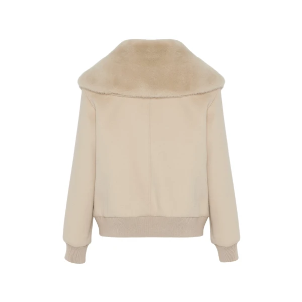 Woman wearing Yves Salomon shearling fur coat – luxury outerwear at Coveti
