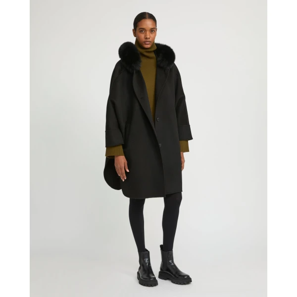 Woman wearing Yves Salomon shearling fur coat – luxury outerwear at Coveti