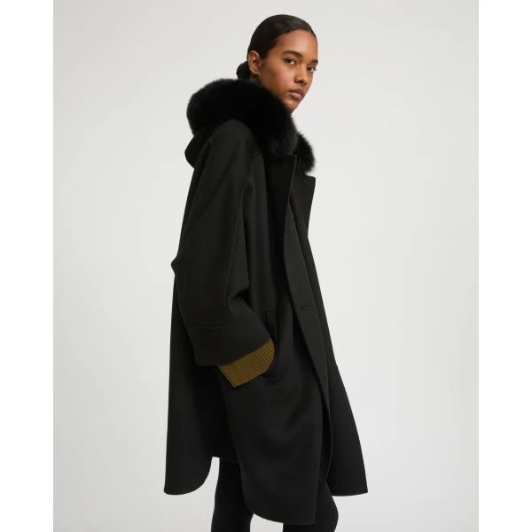Woman wearing Yves Salomon shearling fur coat – luxury outerwear at Coveti