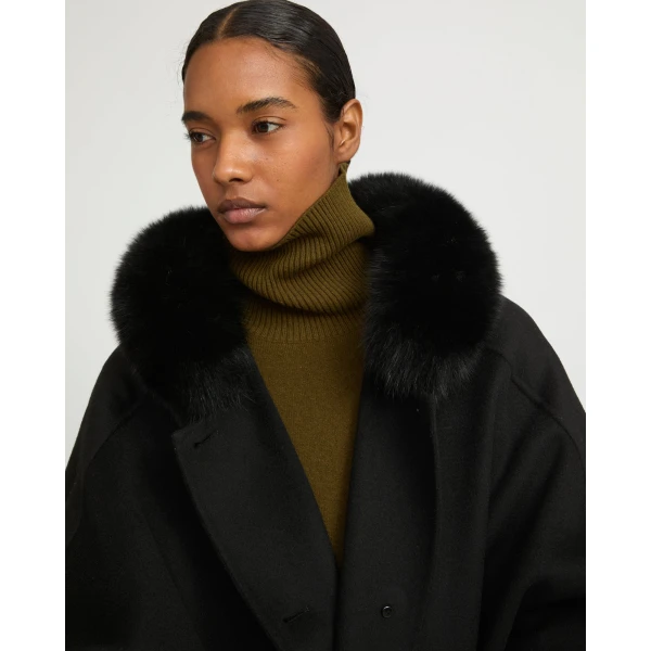Woman wearing Yves Salomon shearling fur coat – luxury outerwear at Coveti