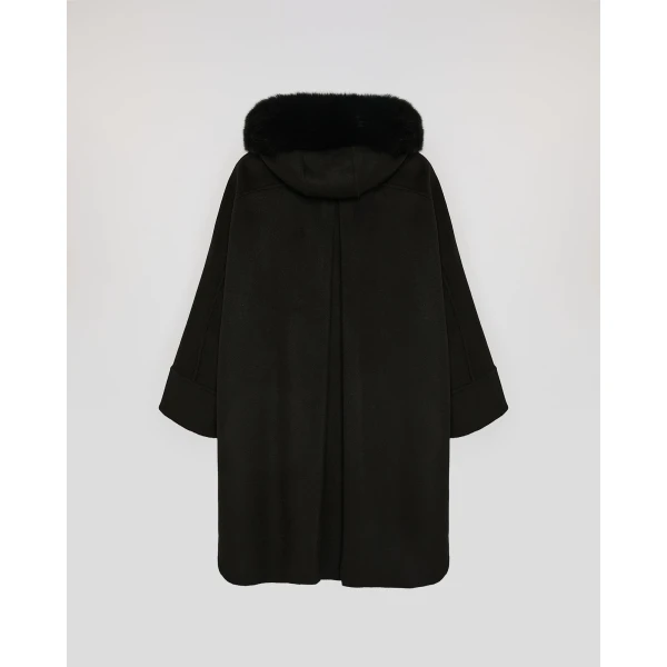 Woman wearing Yves Salomon shearling fur coat – luxury outerwear at Coveti