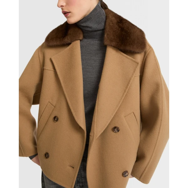 Woman wearing Yves Salomon shearling fur coat – luxury outerwear at Coveti