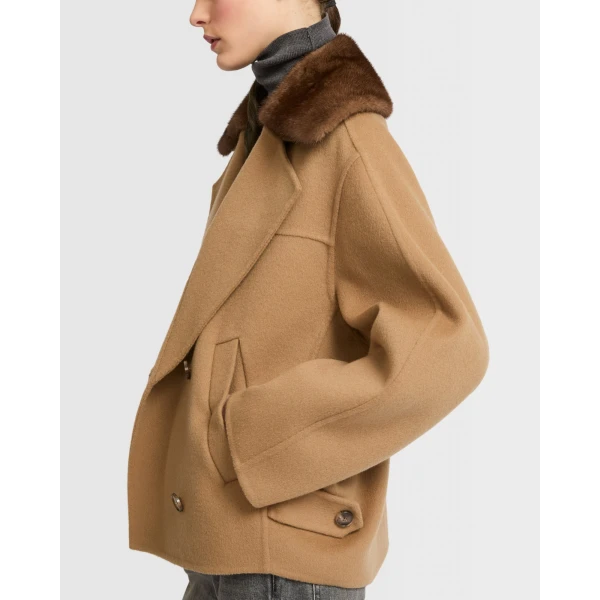 Woman wearing Yves Salomon shearling fur coat – luxury outerwear at Coveti