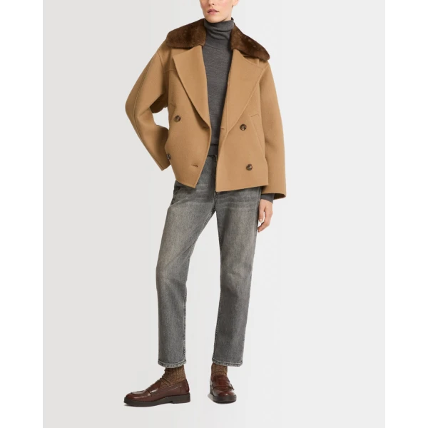 Woman wearing Yves Salomon shearling fur coat – luxury outerwear at Coveti