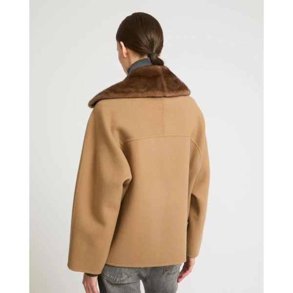 Woman wearing Yves Salomon shearling fur coat – luxury outerwear at Coveti