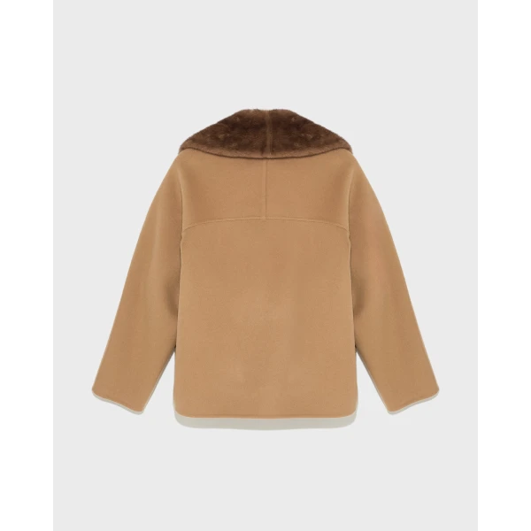 Woman wearing Yves Salomon shearling fur coat – luxury outerwear at Coveti