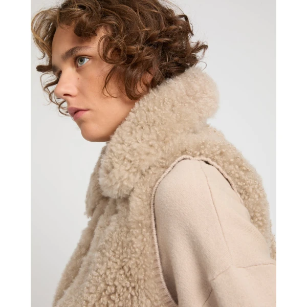 Woman wearing Yves Salomon shearling fur coat – luxury outerwear at Coveti