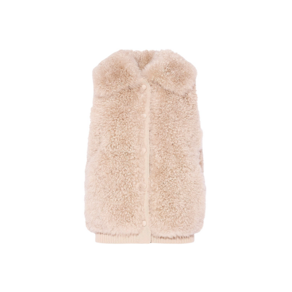 Woman wearing Yves Salomon shearling fur coat – luxury outerwear at Coveti