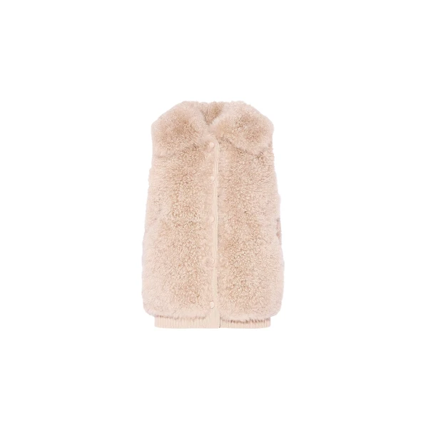 Woman wearing Yves Salomon shearling fur coat – luxury outerwear at Coveti