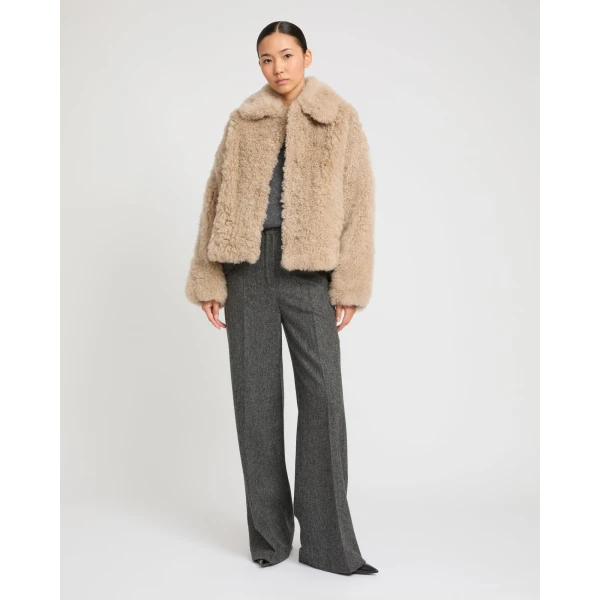 Woman wearing Yves Salomon shearling fur coat – luxury outerwear at Coveti