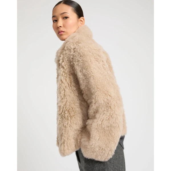 Woman wearing Yves Salomon shearling fur coat – luxury outerwear at Coveti