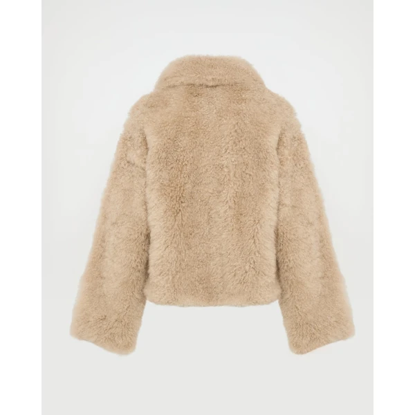 Woman wearing Yves Salomon shearling fur coat – luxury outerwear at Coveti
