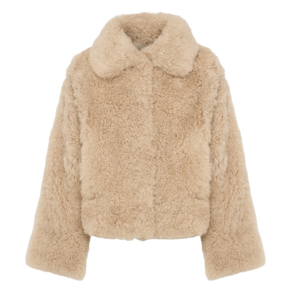 Woman wearing Yves Salomon shearling fur coat – luxury outerwear at Coveti