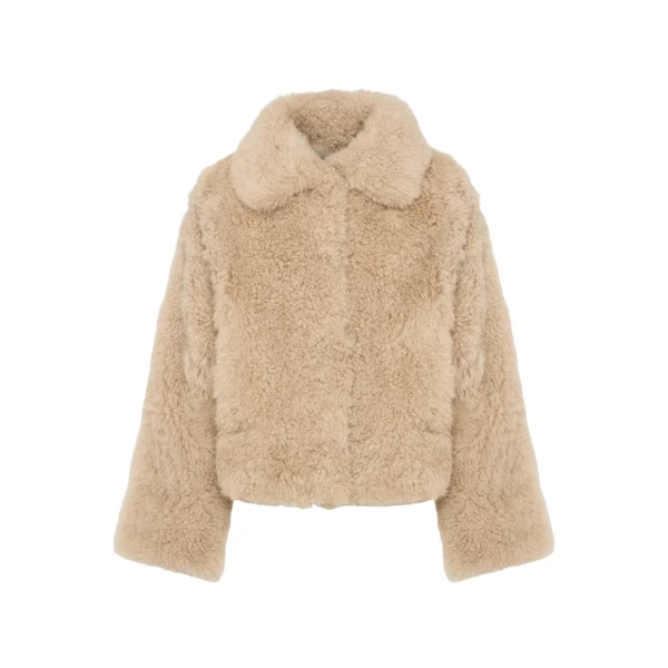 Woman wearing Yves Salomon shearling fur coat – luxury outerwear at Coveti