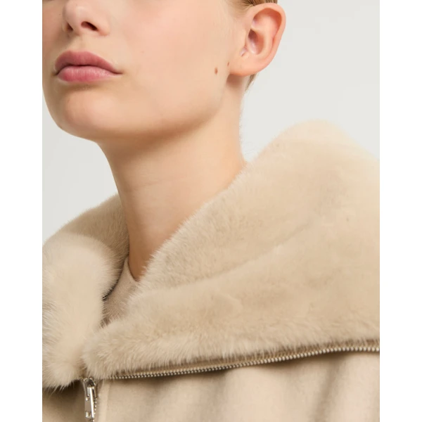 Woman wearing Yves Salomon shearling fur coat – luxury outerwear at Coveti