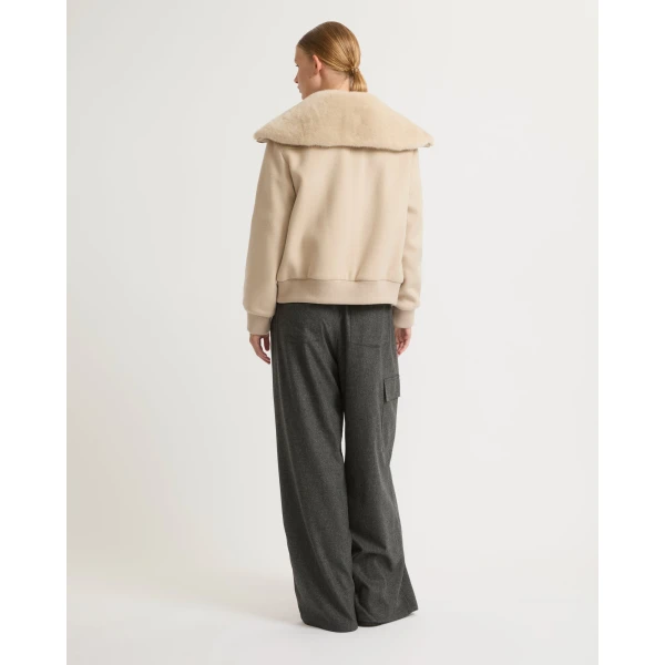 Woman wearing Yves Salomon shearling fur coat – luxury outerwear at Coveti