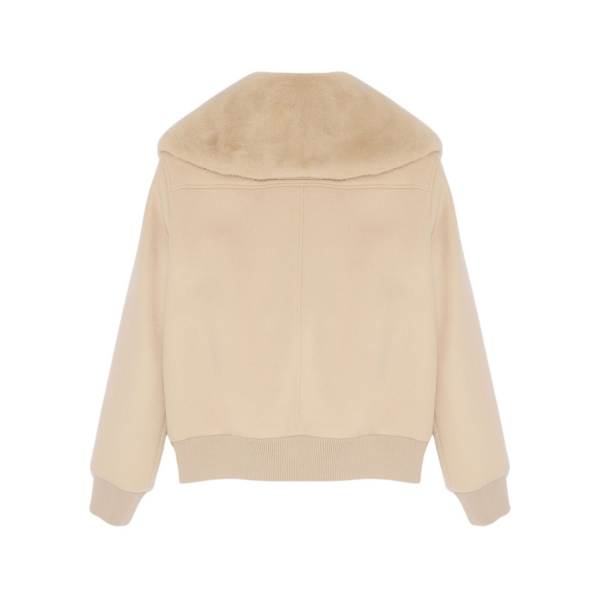 Woman wearing Yves Salomon shearling fur coat – luxury outerwear at Coveti