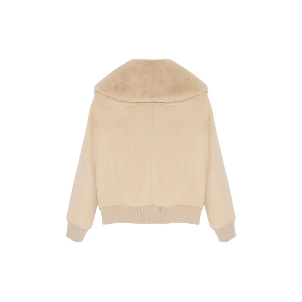 Woman wearing Yves Salomon shearling fur coat – luxury outerwear at Coveti