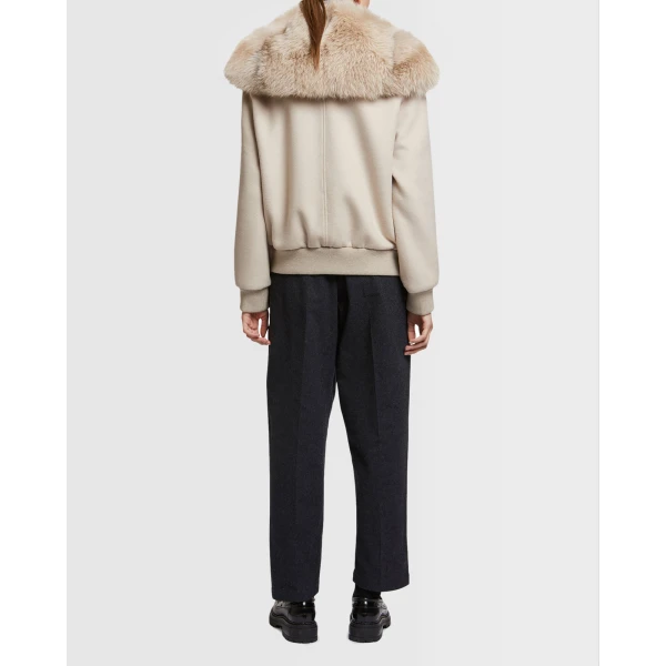 Woman wearing Yves Salomon shearling fur coat – luxury outerwear at Coveti