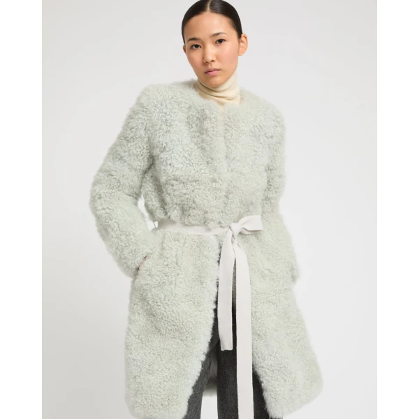 Woman wearing Yves Salomon shearling fur coat – luxury outerwear at Coveti