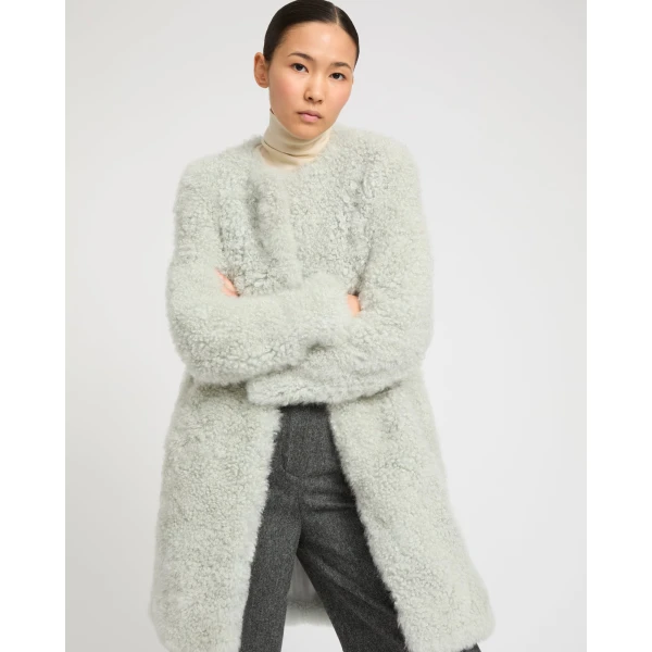 Woman wearing Yves Salomon shearling fur coat – luxury outerwear at Coveti
