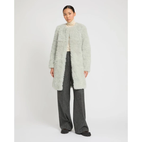 Woman wearing Yves Salomon shearling fur coat – luxury outerwear at Coveti