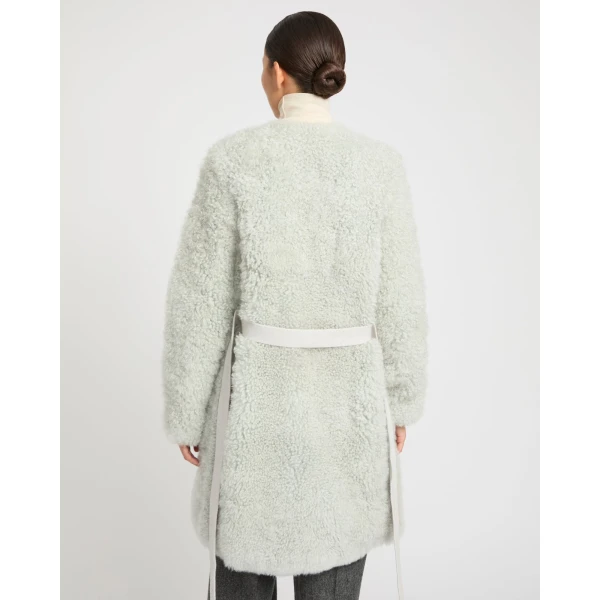 Woman wearing Yves Salomon shearling fur coat – luxury outerwear at Coveti