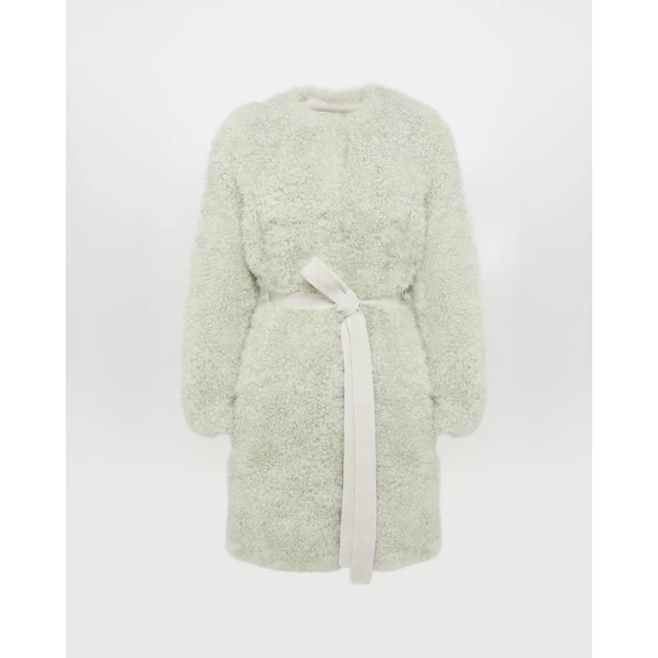 Woman wearing Yves Salomon shearling fur coat – luxury outerwear at Coveti