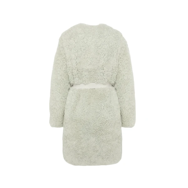 Woman wearing Yves Salomon shearling fur coat – luxury outerwear at Coveti