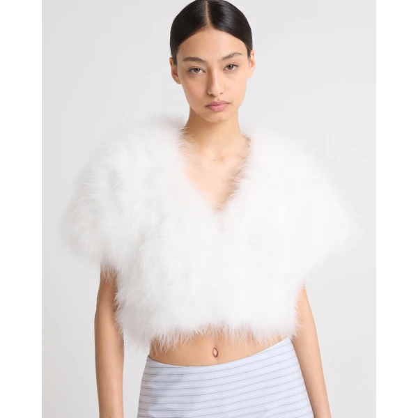 Woman wearing Yves Salomon shearling fur coat – luxury outerwear at Coveti