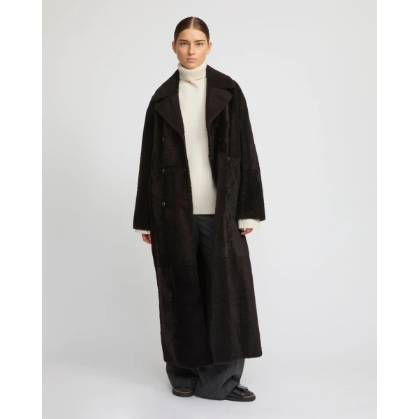 Woman wearing Yves Salomon shearling fur coat – luxury outerwear at Coveti