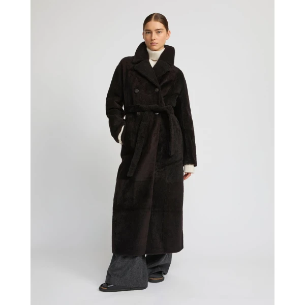 Woman wearing Yves Salomon shearling fur coat – luxury outerwear at Coveti