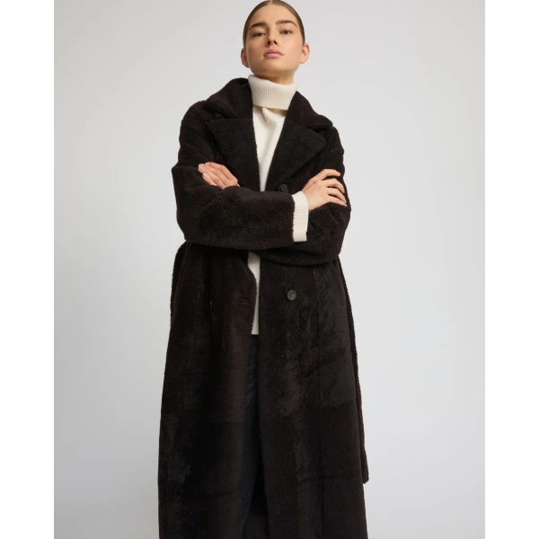 Woman wearing Yves Salomon shearling fur coat – luxury outerwear at Coveti