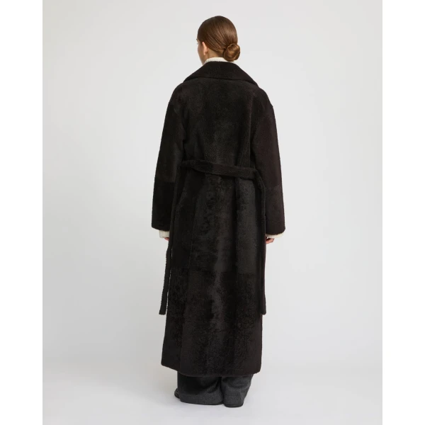 Woman wearing Yves Salomon shearling fur coat – luxury outerwear at Coveti