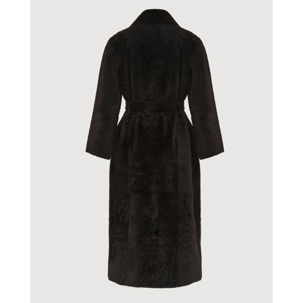 Woman wearing Yves Salomon shearling fur coat – luxury outerwear at Coveti