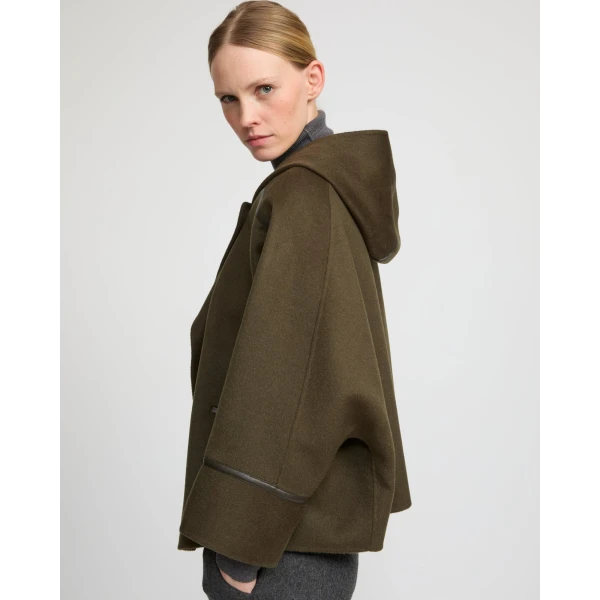 Woman wearing Yves Salomon shearling fur coat – luxury outerwear at Coveti